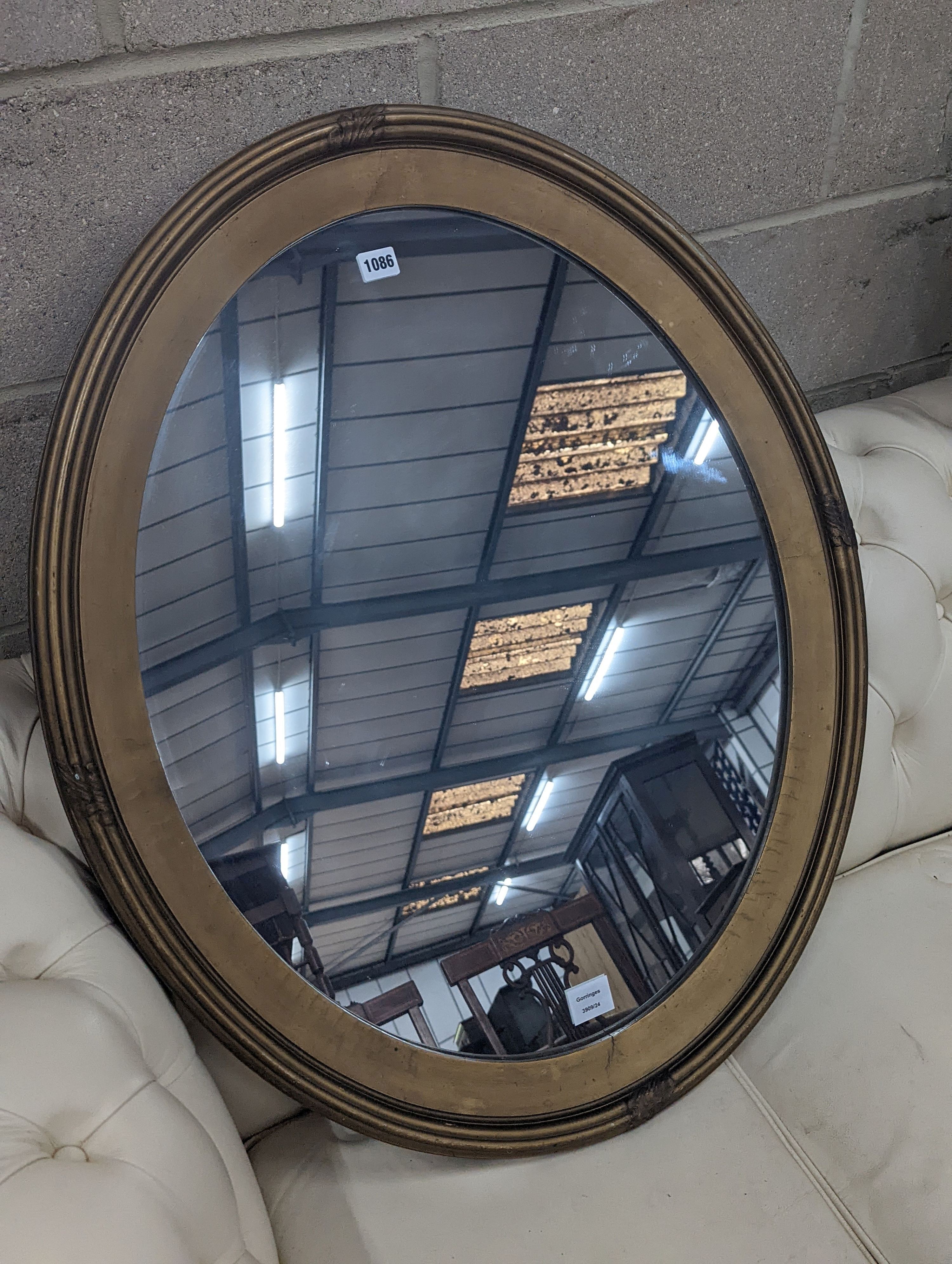 An Edwardian oval gilt framed wall mirror, width 72cm, height 87cm